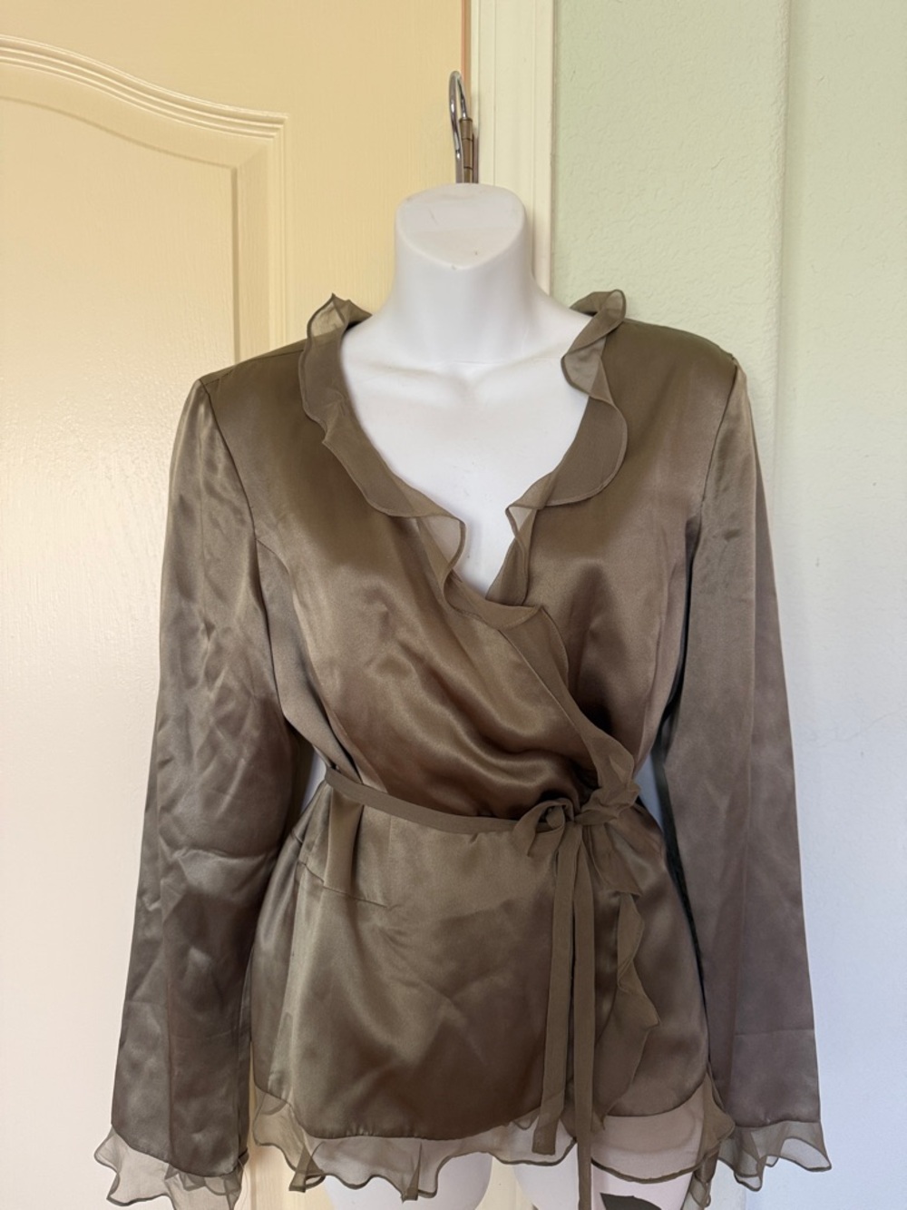 Elegant silk blouse with ruffeled trim.
